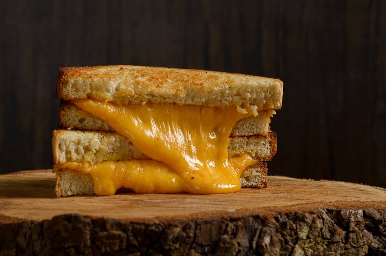 Gourmet grilled cheese sandwich on rustic wooden table